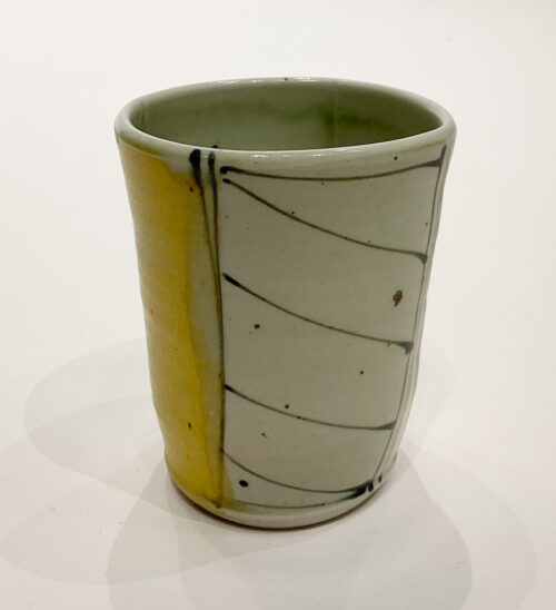 Delores Fortuna tumbler alternating with black and white stripes and yellow panels